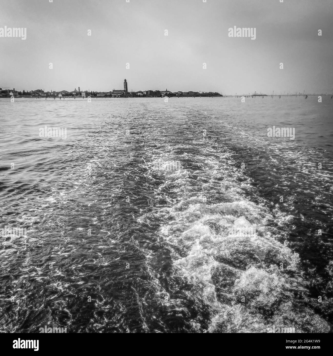 The lagoon view from a boat taxi leaving behind it Venice, Black and white photography Stock Photo
