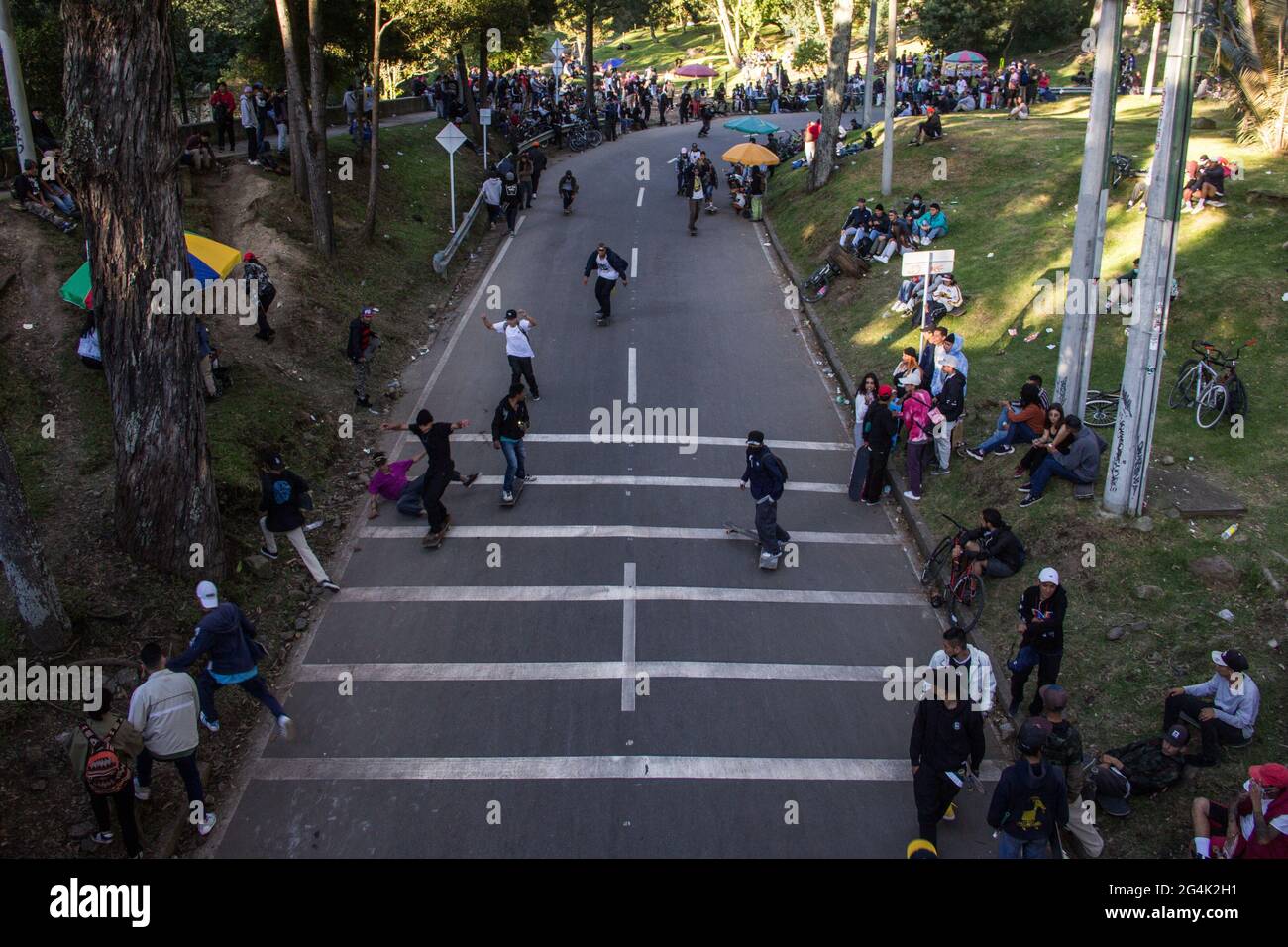 Skaters downhill the 'Parque Nacional' main road during the international World Skateboarding Day in Bogota, Colombia on June 21, 2021. Stock Photo