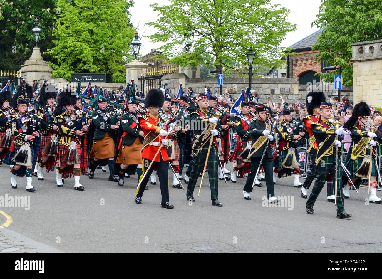 Military marching band marching out of Windsor Castle during ceremony