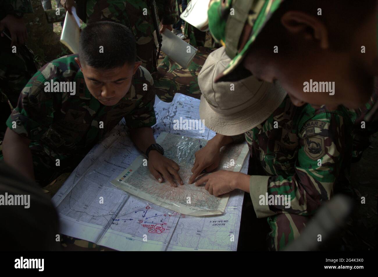 Mount Salak, West Java, Indonesia. May 10, 2012. Military personnels plotting the possible locations on the map, before the search mission for the Sukhoi Superjet 100 (SSJ-100) plane that crashed in the region on May 9. Stock Photo