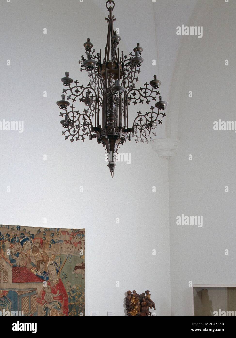 . Candle arm belonging to a candle wreath of three heights with maria chapel in the middle. The arm is bent twice and has eleven leaves. The fat catcher rests at the end, which has a vertical knurled edge on the underside with cross block motifs. The candle holder is six more flaky with a perforated side and back and has a vertically annular bottom. This is the sixth arm of the middle ring (center of the bars), numbered with 6 dots. Stock Photo