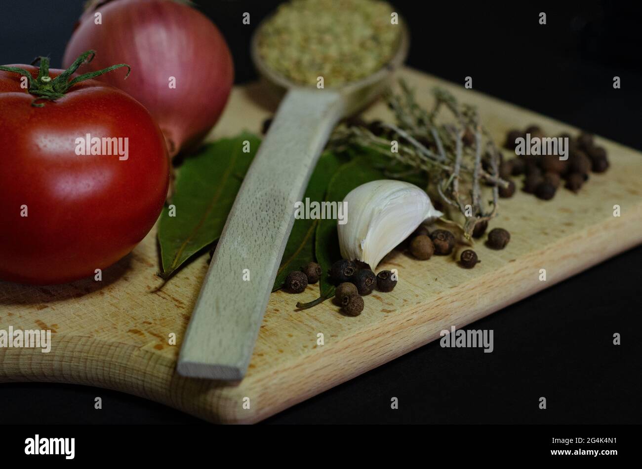Soft Spice Notes Soft focus of spices on a wooden board against a black background Stock ...