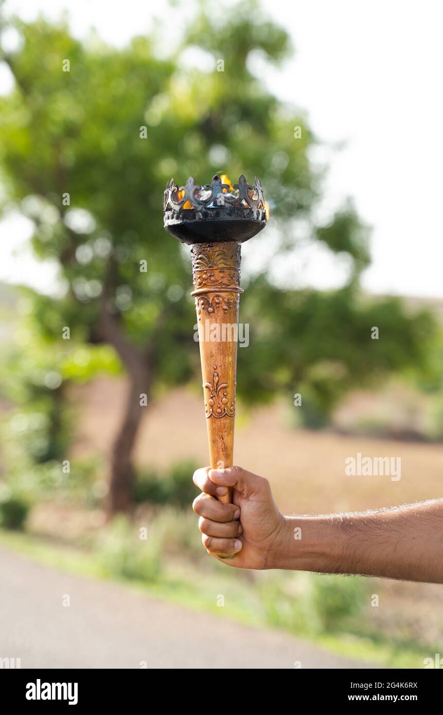 A man holding a fire torch and burning a big piece of oak creating flames  and smoke, old jappanese shou sugi ban technique. black wooden material.  Gra Stock Photo - Alamy