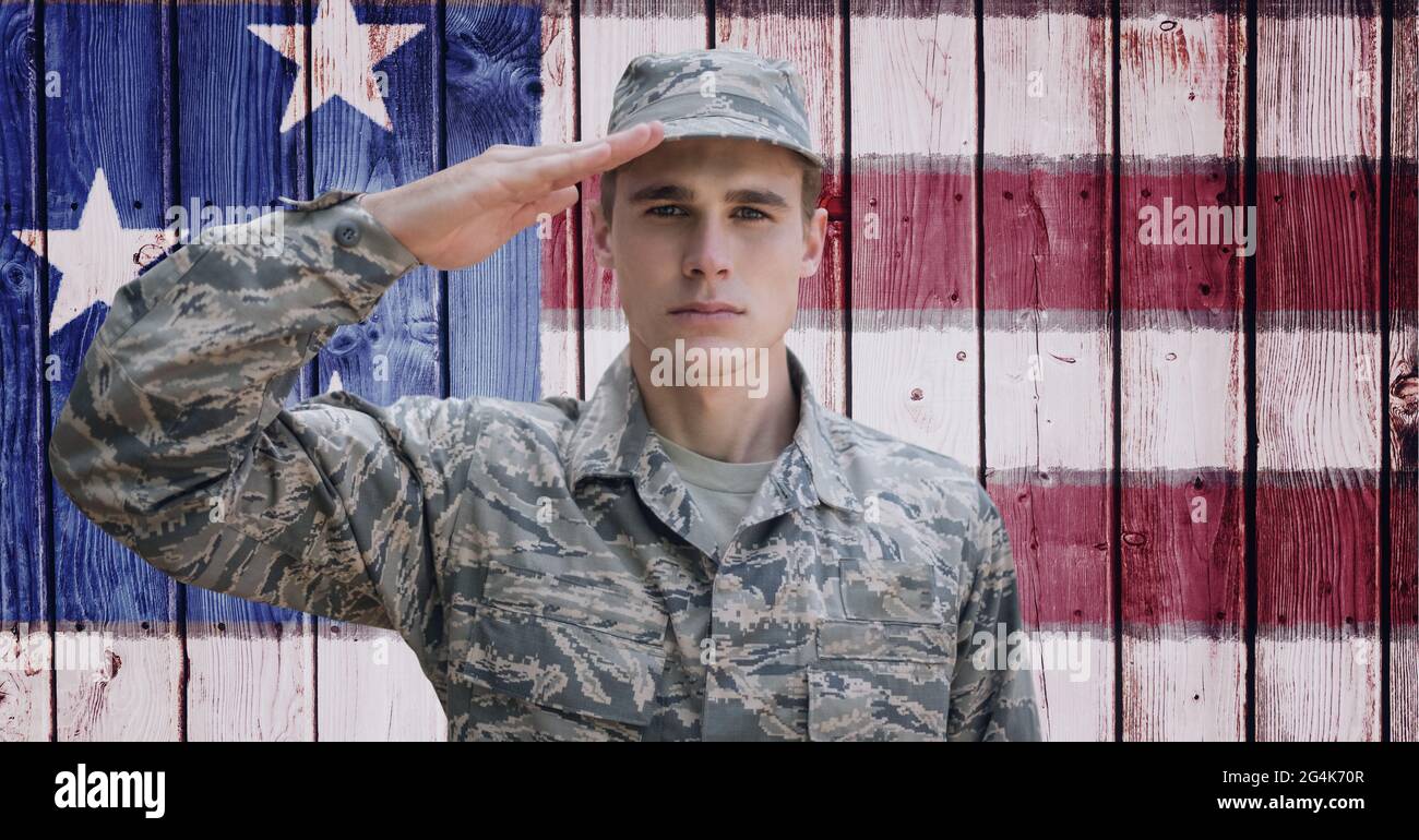Composition of male soldier saluting over american flag Stock Photo - Alamy