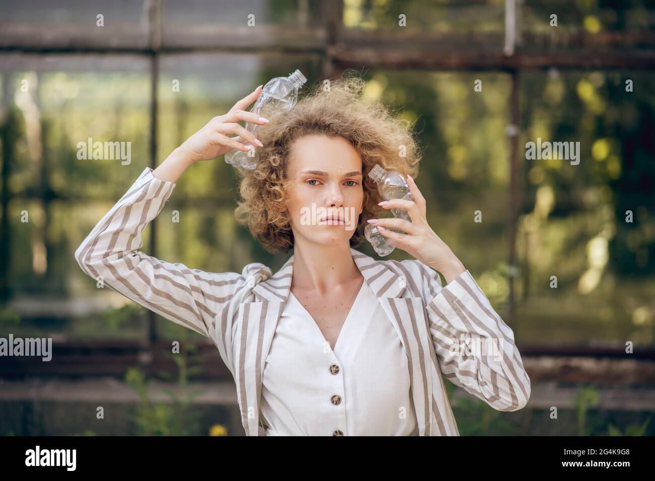 Fair-haired woman holding plastic bottles in hands Stock Photo