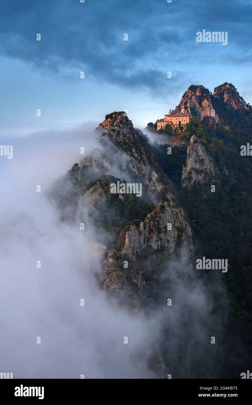 Queralt Sanctuary and Sant Pere de Madrona hermitage at sunrise, with fog. Seen from the Agulles del Mercadal summit (Berguedà, Catalonia, Spain) Stock Photo