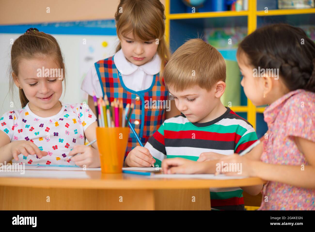 Cute little children drawing and studying at daycare Stock Photo - Alamy