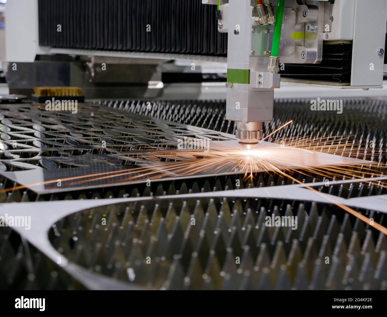 Industrial laser cutting of metal. Automatic machine in the factory. Stock Photo