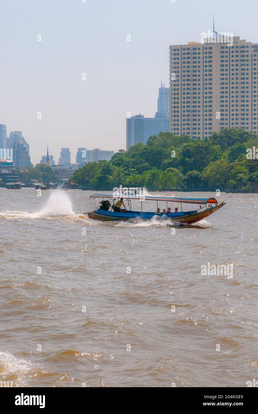 A traditional Thai long-tail boat on the Chao Phraya river in Bangkok in Thailand in South East Asia. Stock Photo