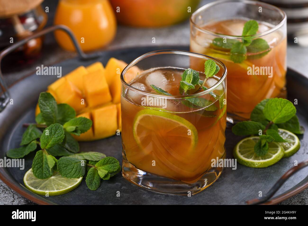 Mango iced tea with lime and mint. Refreshing organic soft drink Stock Photo