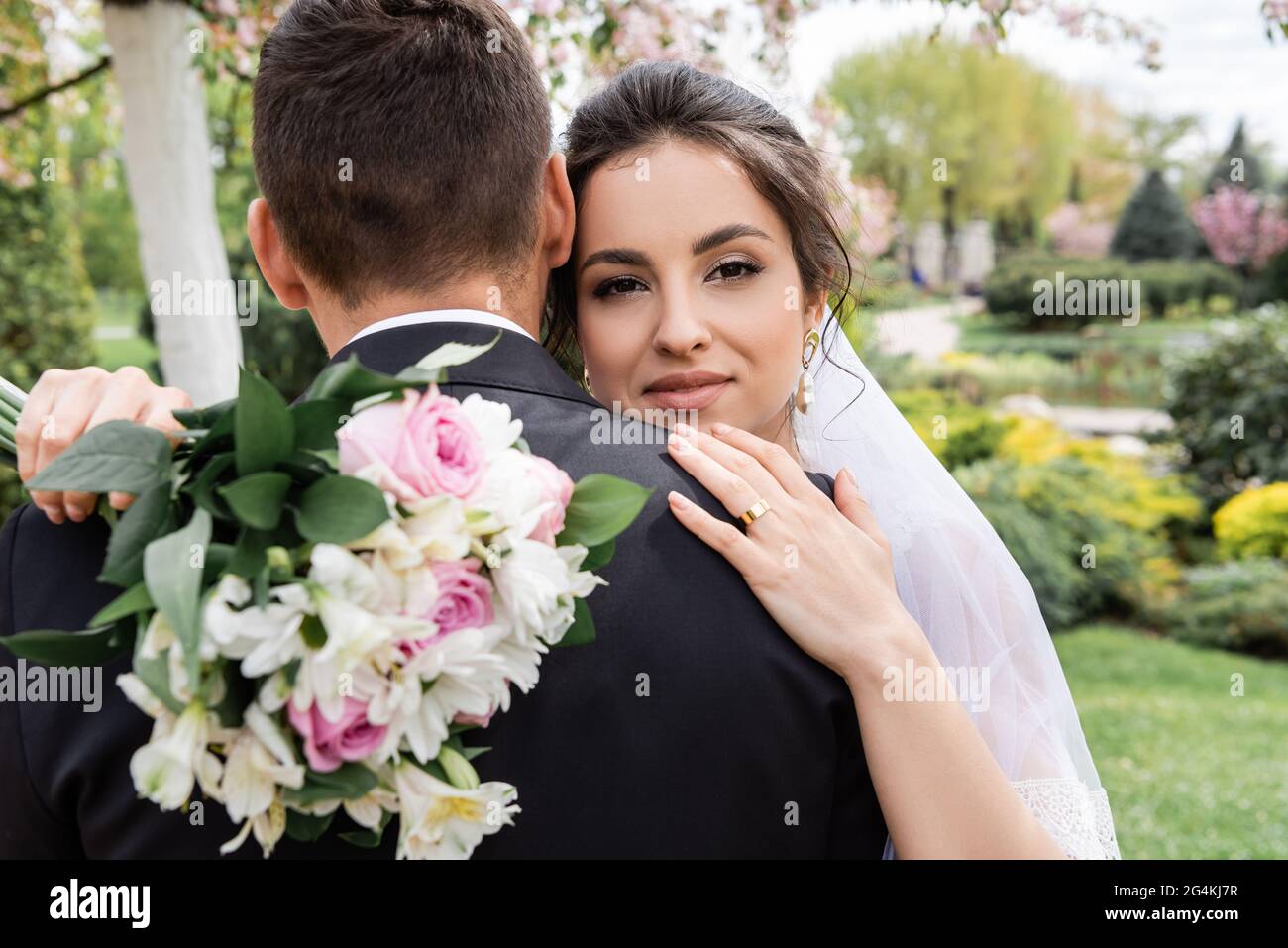 Bride groom embrace in park hi-res stock photography and images - Alamy