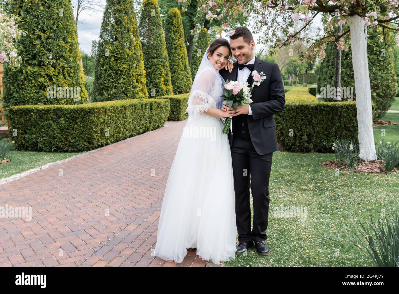 Bride groom embrace in park hi-res stock photography and images - Alamy