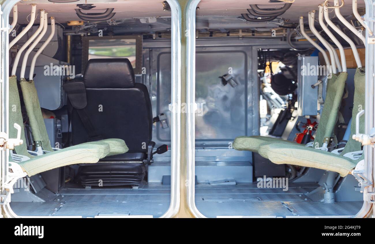 Minimalistic, rigid interior of the interior of an infantry fighting vehicle, armored personnel carrier. Selective focus, copy space. Stock Photo