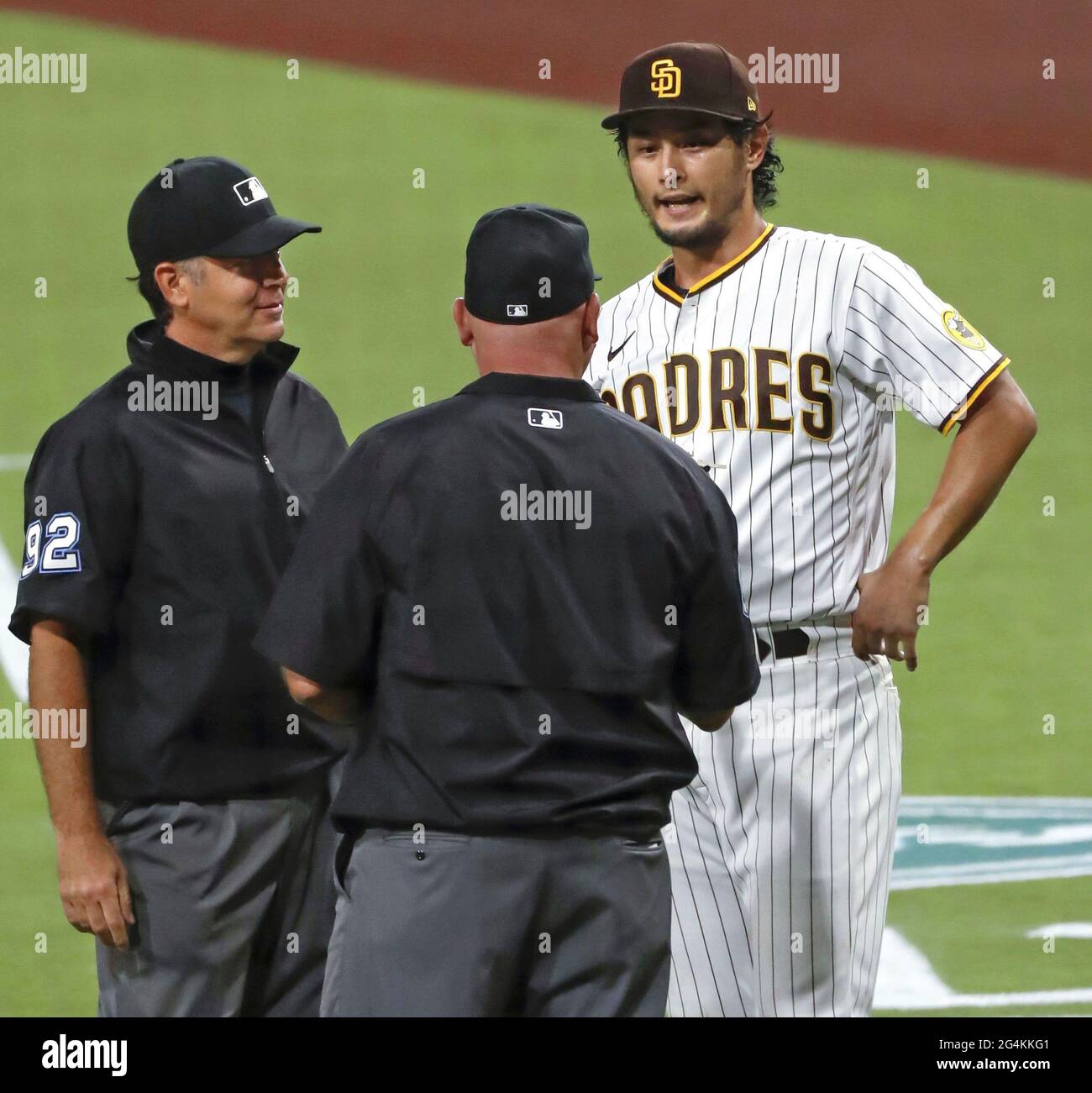 Umpires check San Diego Padres pitcher Yu Darvish's glove and hands for