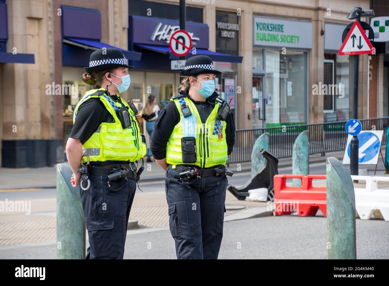Sheffield UK: 17th April 2021: Two policewomen wearing masks policing the streets of Sheffield city centre as it reopens after the pandemic lockdown, Stock Photo