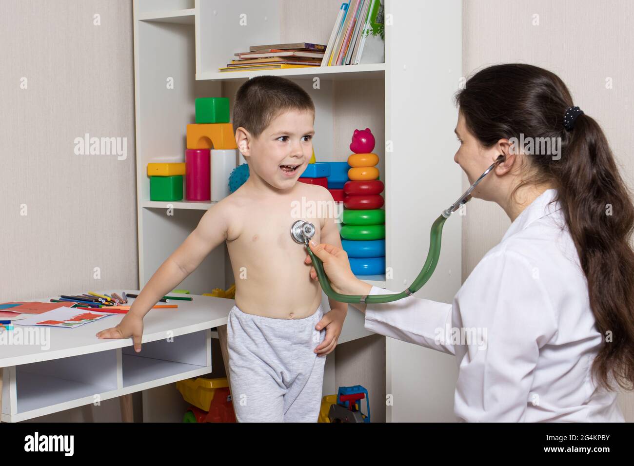 Pediatric examination of a child with a stethoscope. Little boy and