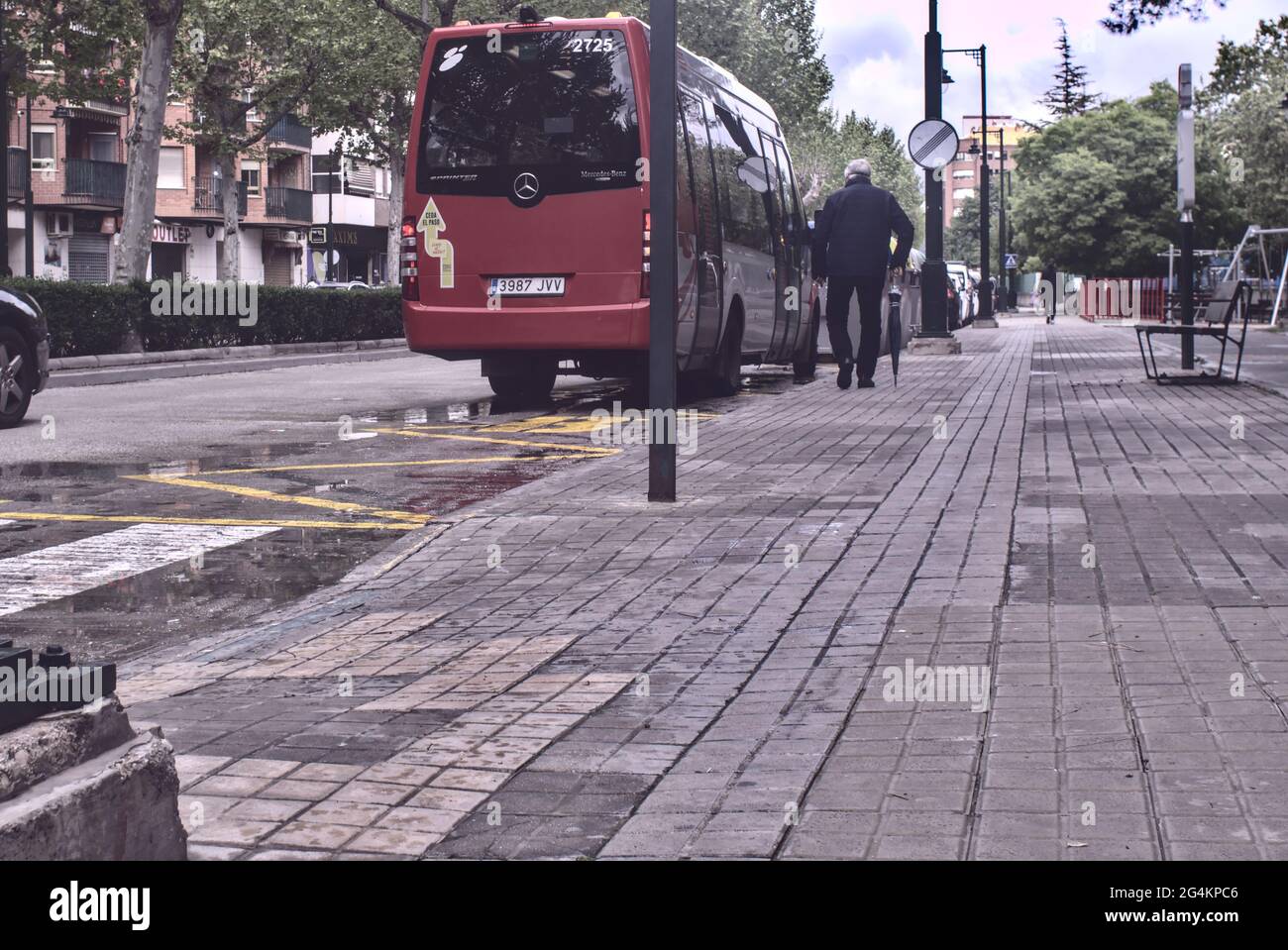 ALCOY, SPAIN - May 25, 2021: Alcoy, Alicante, Spain - April 2021. Elderly  man approaches Red bus stopped at the bus stop to get on Stock Photo - Alamy