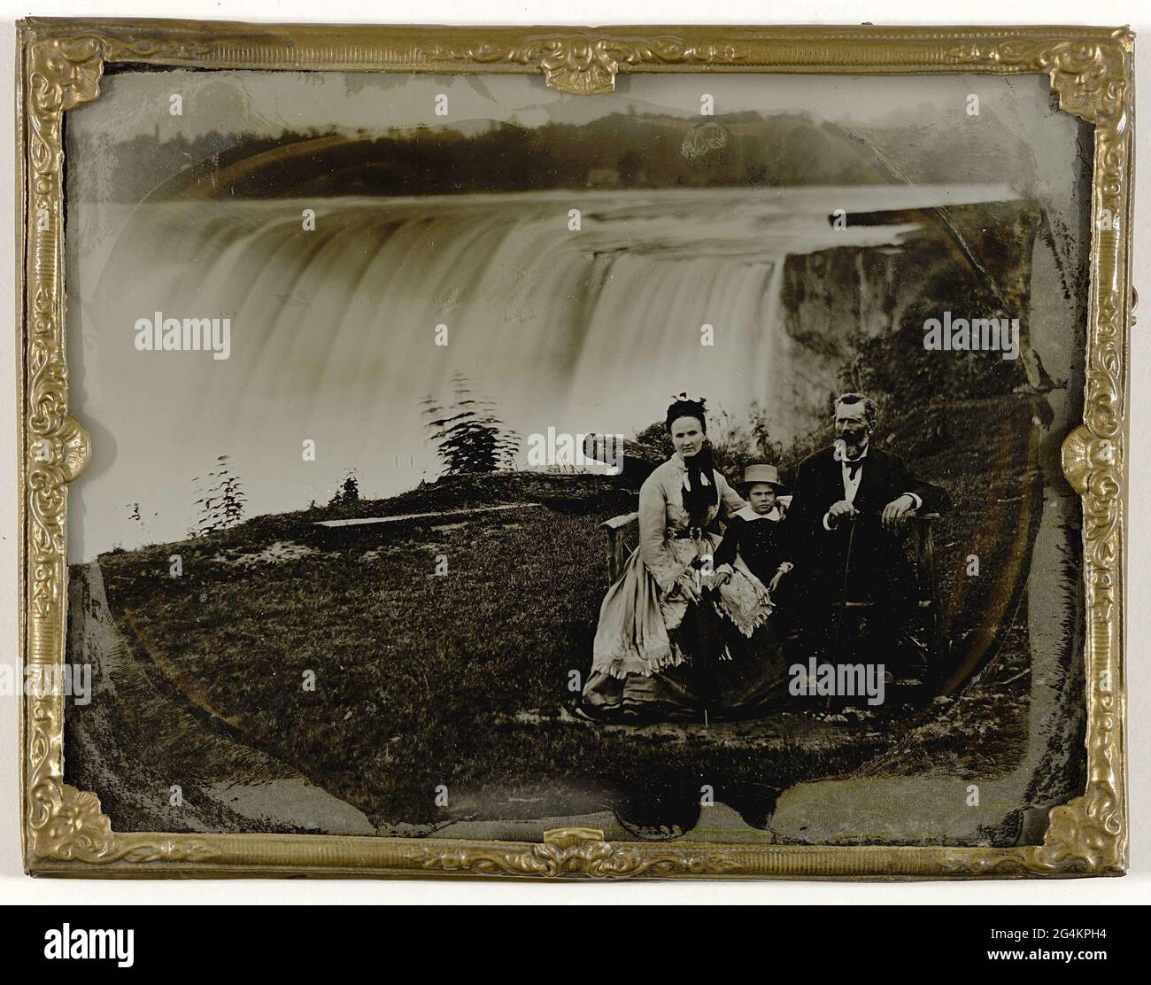 . Visiting the breathtaking Niagara Falls required wearing raingear. This family had itself portrayed twice by the ambrotypist: once with and once without raincoats in the exact same spot. The famous tourist attraction buzzed with photographic activity. Visitors and travellers were portrayed by all manner of photographers. And pictures of the Falls were for sale everywhere. Stock Photo