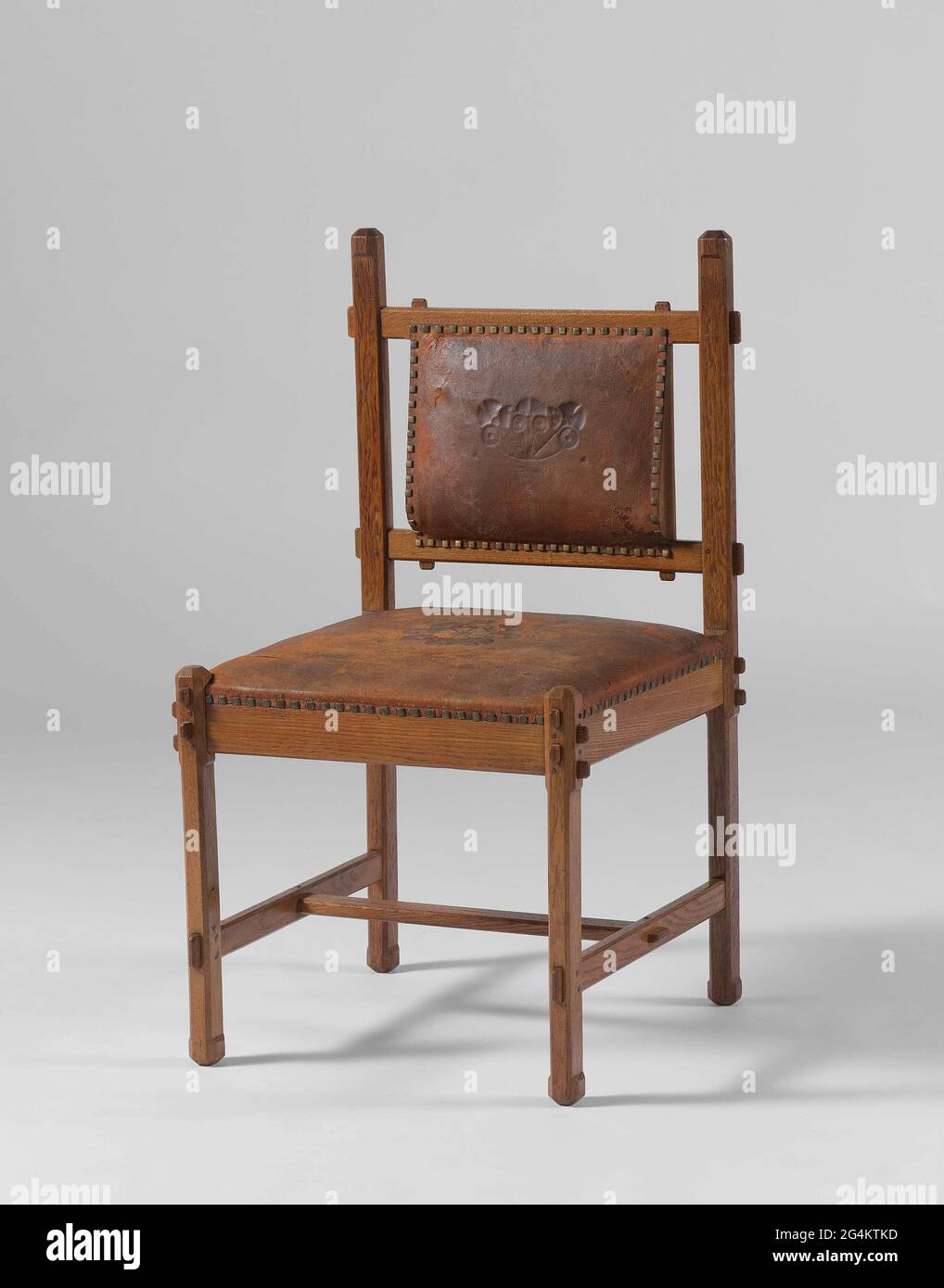 https://c8.alamy.com/comp/2G4KTKD/chair-part-of-a-pair-of-oak-with-straight-legs-with-beveled-corners-a-square-seat-covered-with-brown-leather-with-a-stamped-stylized-flower-in-the-middle-in-the-back-a-brown-leather-panel-with-a-stamped-stylized-branch-amsterdam-gebroeders-vogel-1907-to-the-design-of-aj-kropholler-with-the-cooperation-of-m-kropholler-and-jf-steel-the-leather-upholstery-to-design-of-s-jessurum-de-mesquita-manufactured-for-mr-romijn-2G4KTKD.jpg