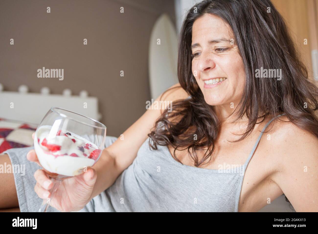 Attractive middleaged Spanish woman posing with a glass of