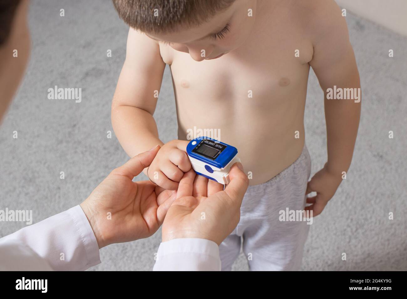 The pediatrician measures the child's blood oxygen level with a pulse ...