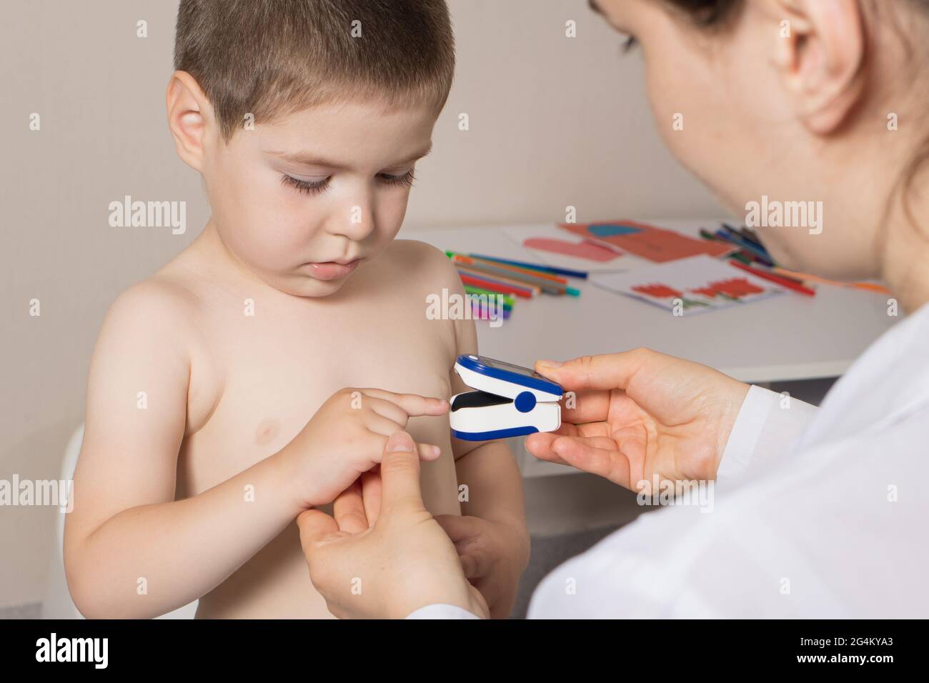 The pediatrician measures the child's blood oxygen level with a pulse ...