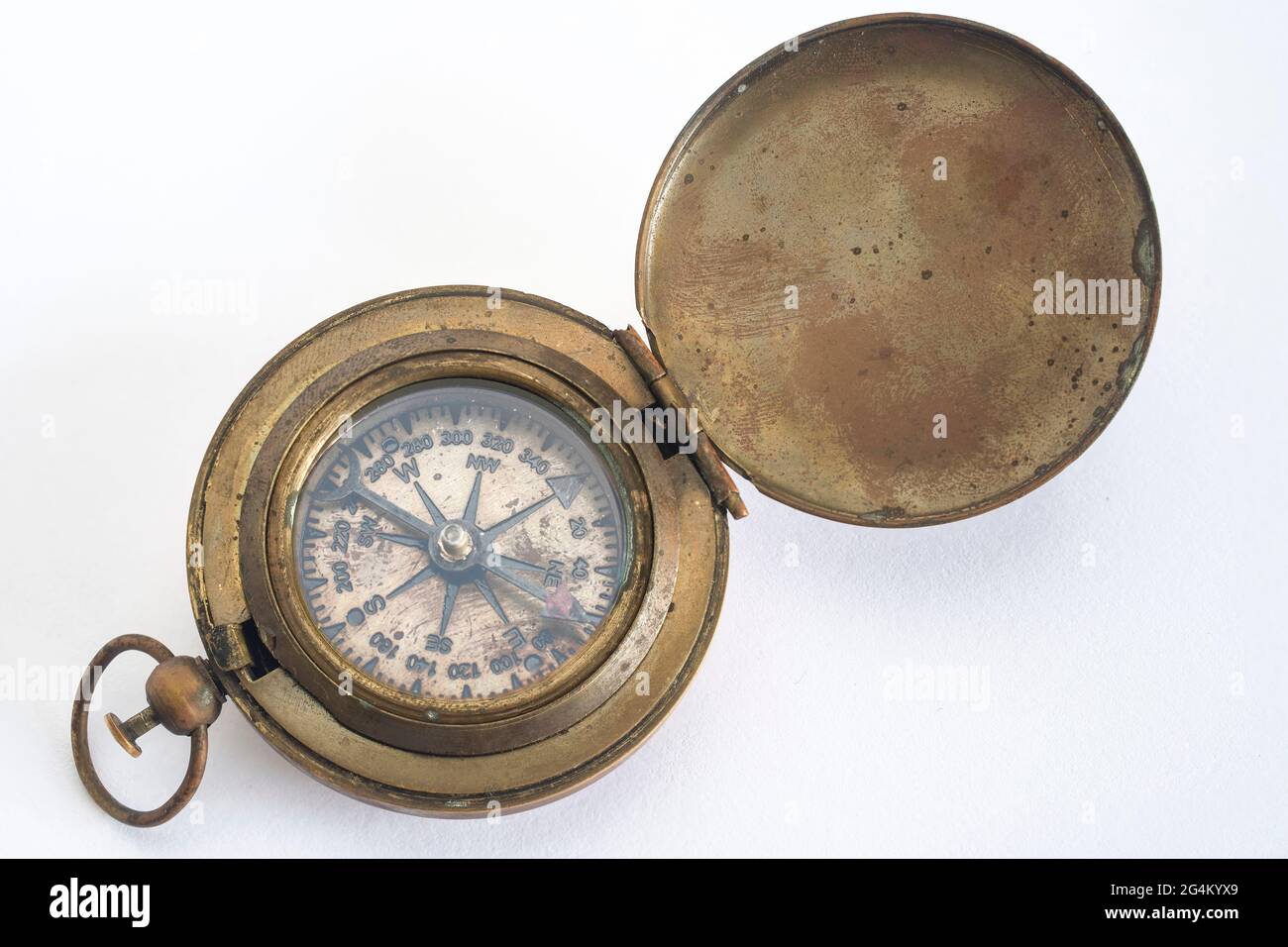 Old brass marine compass on a white background Stock Photo