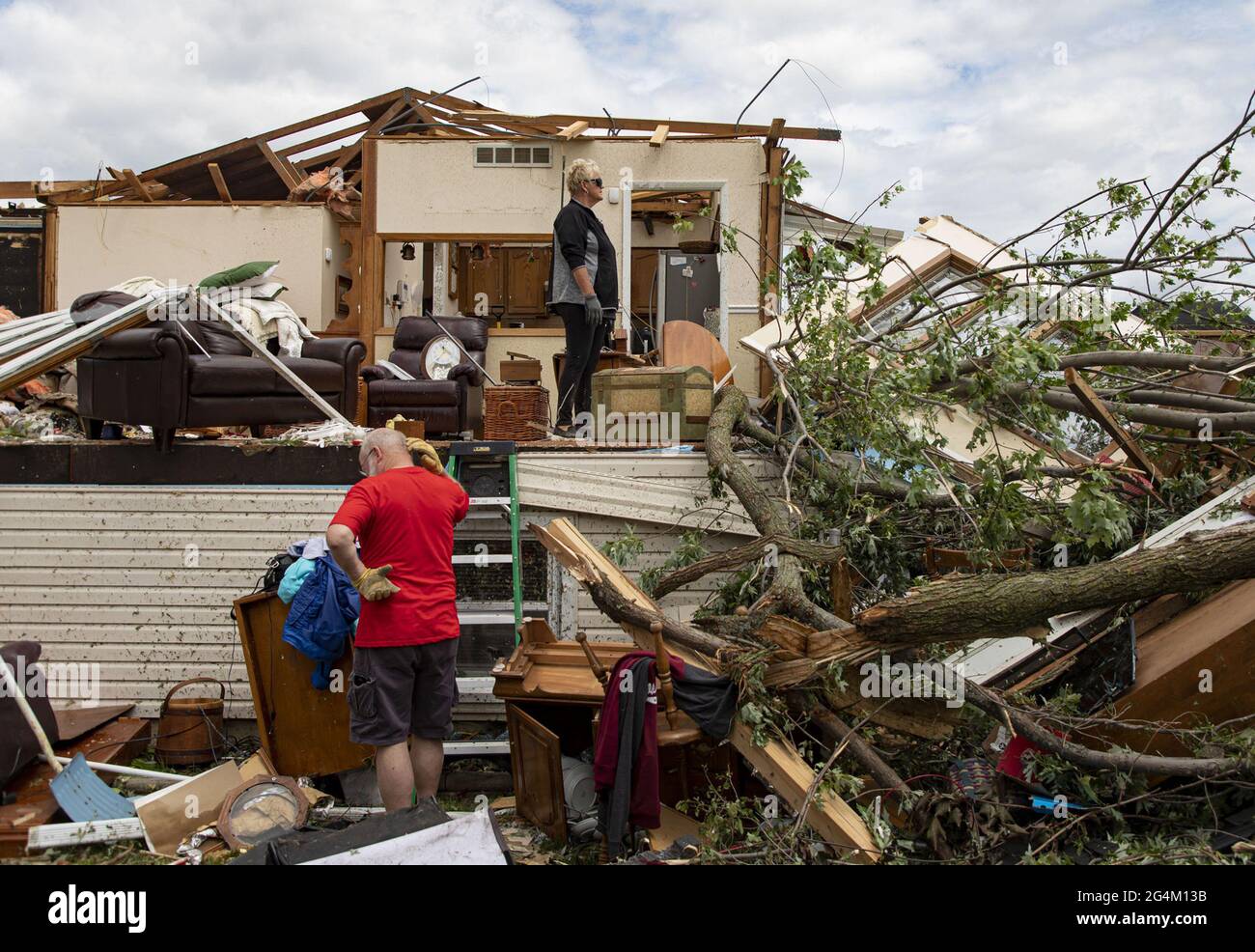 Mike and Sandra Barr help salvage belongings from his sister's heavily