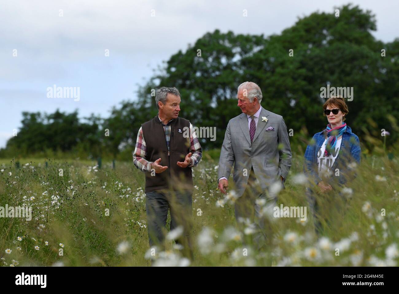 The Prince of Wales walks with FarmED founders Ian and Celene Wilkinson during his visit to