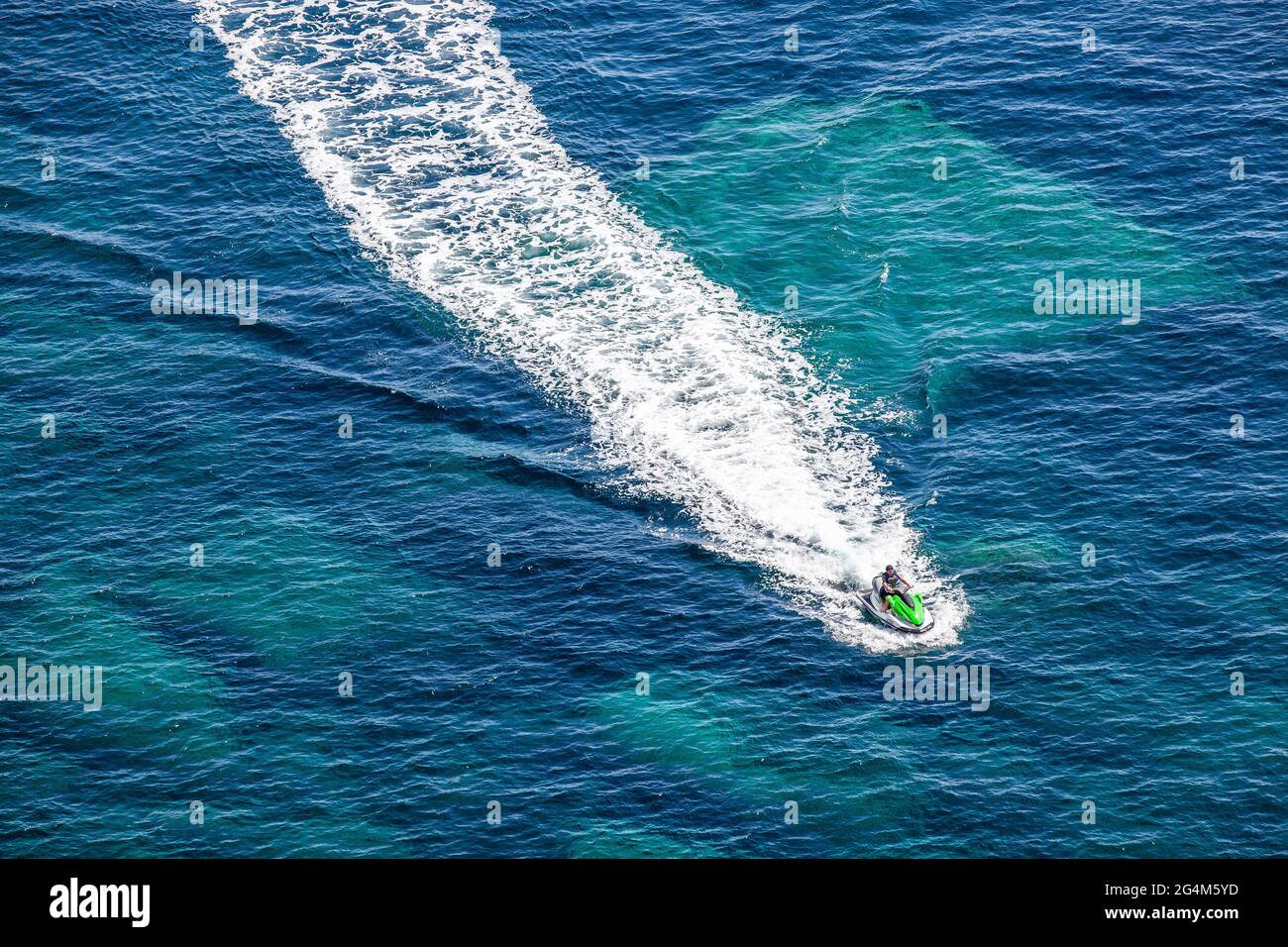 Wake of a personal watercraft on the turquoise sea in Bonifacio, Corsica, France Stock Photo