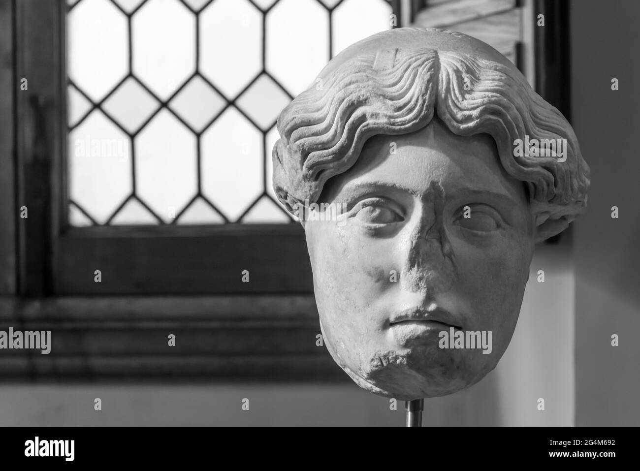 Black and white photo in close-up of ruined head of ancient roman statue Stock Photo
