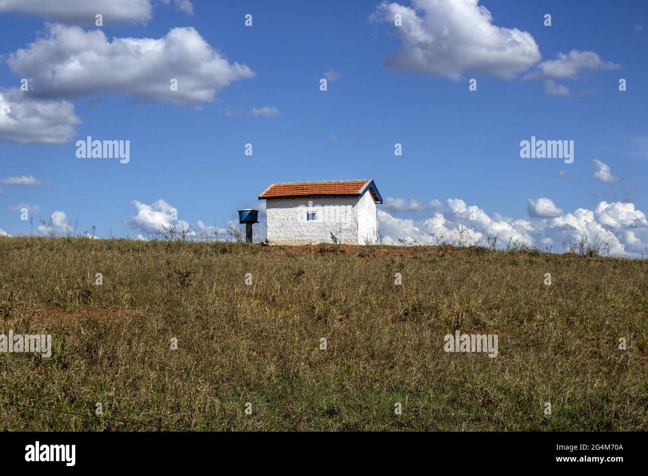 Farmhouse in a farmland under the blue cloudy sky Stock Photo - Alamy