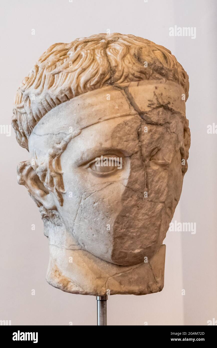 Close-up on ruined young male face of ancient roman statue head Stock Photo