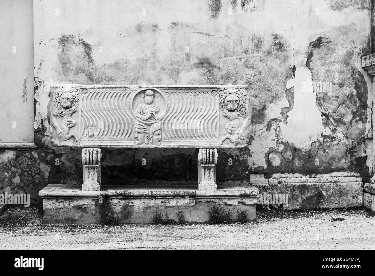 Black and white photo of ancient decorated coffin in marble Stock Photo