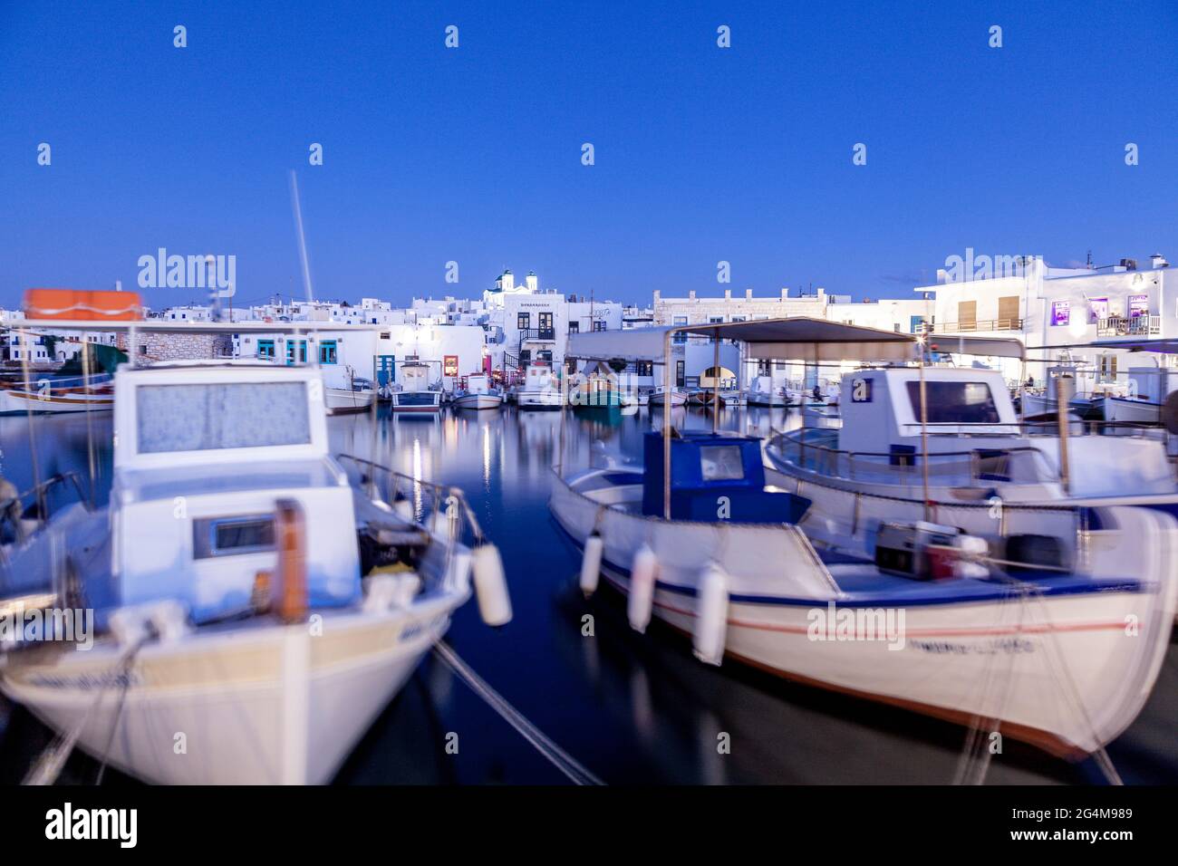 Beautiful fishing port of Naousa during blue hour, in Paros island, Cyclades islands, Greece, Europe. Stock Photo