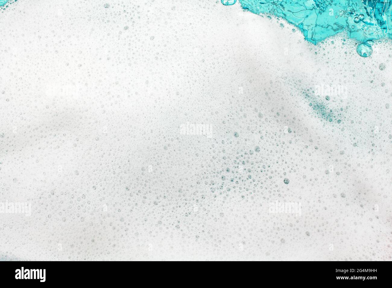 White foam blue water background closeup, sea or ocean foam wave pattern, froth bubbles texture, soap spume backdrop, cleaning soap sud lather surface Stock Photo