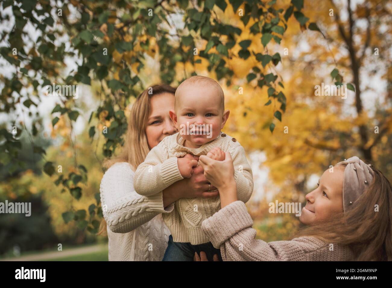 Happy family on autumn park. Mother and daughter walking in the Park Stock Photo
