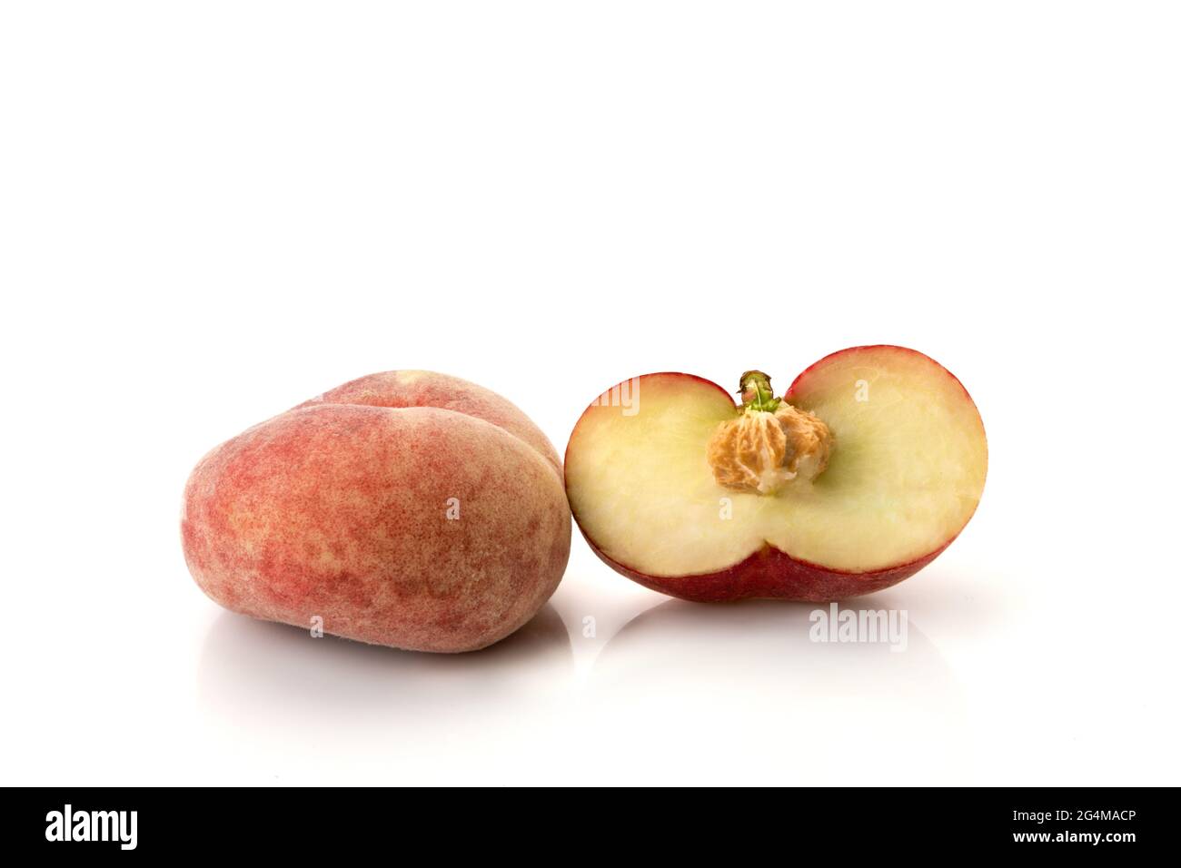 Donut peaches isolated on white background, one Saturn peaches cut in