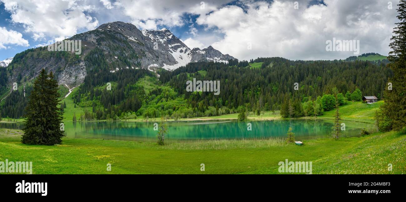panorama of idyllic Lake Lauenensee in spring, Bernese Alps, Switzerland Stock Photo