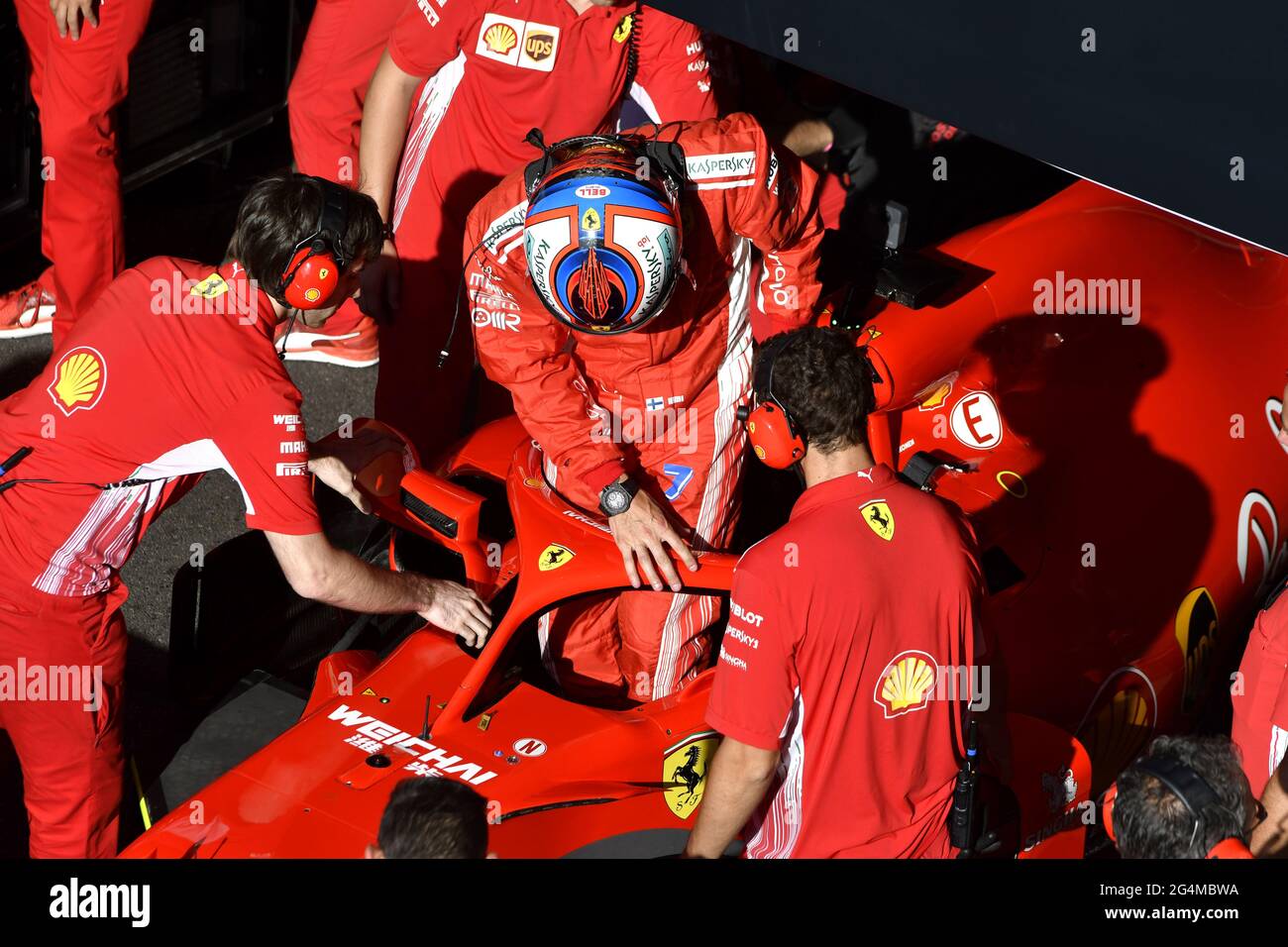 Ferrari's pit stop crew working around the Ferrari Formula One at the Ferrari' box, during an exhibition in MIlan, Italy. Stock Photo