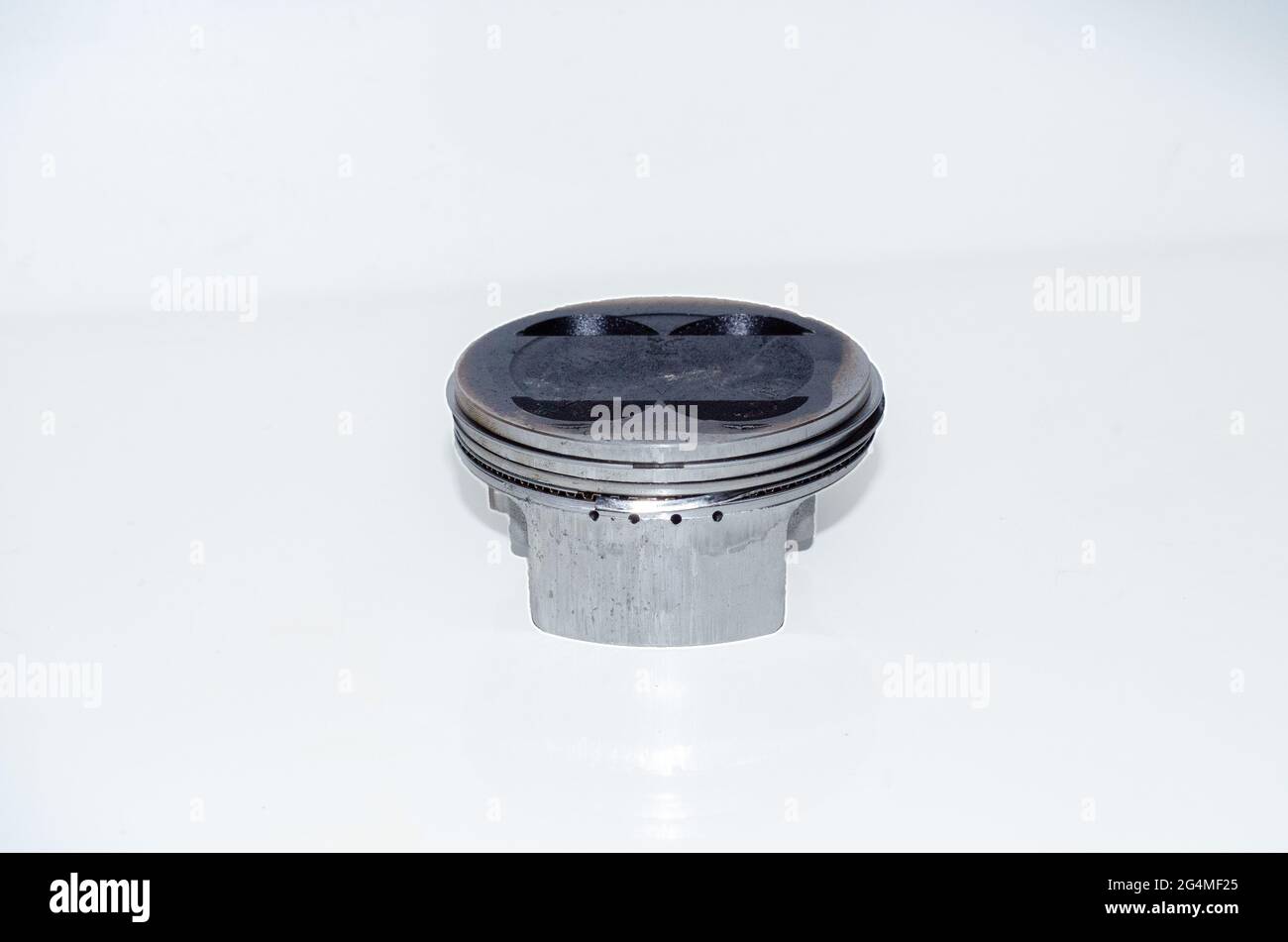 Isolated shot of a piston with ring damage and impact marks Stock Photo