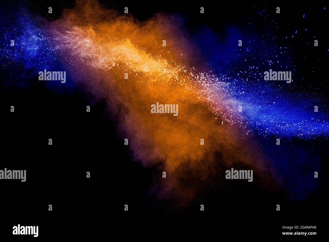Orange blue  powder explosion on black background.Orange blue color dust splash clouds. Stock Photo