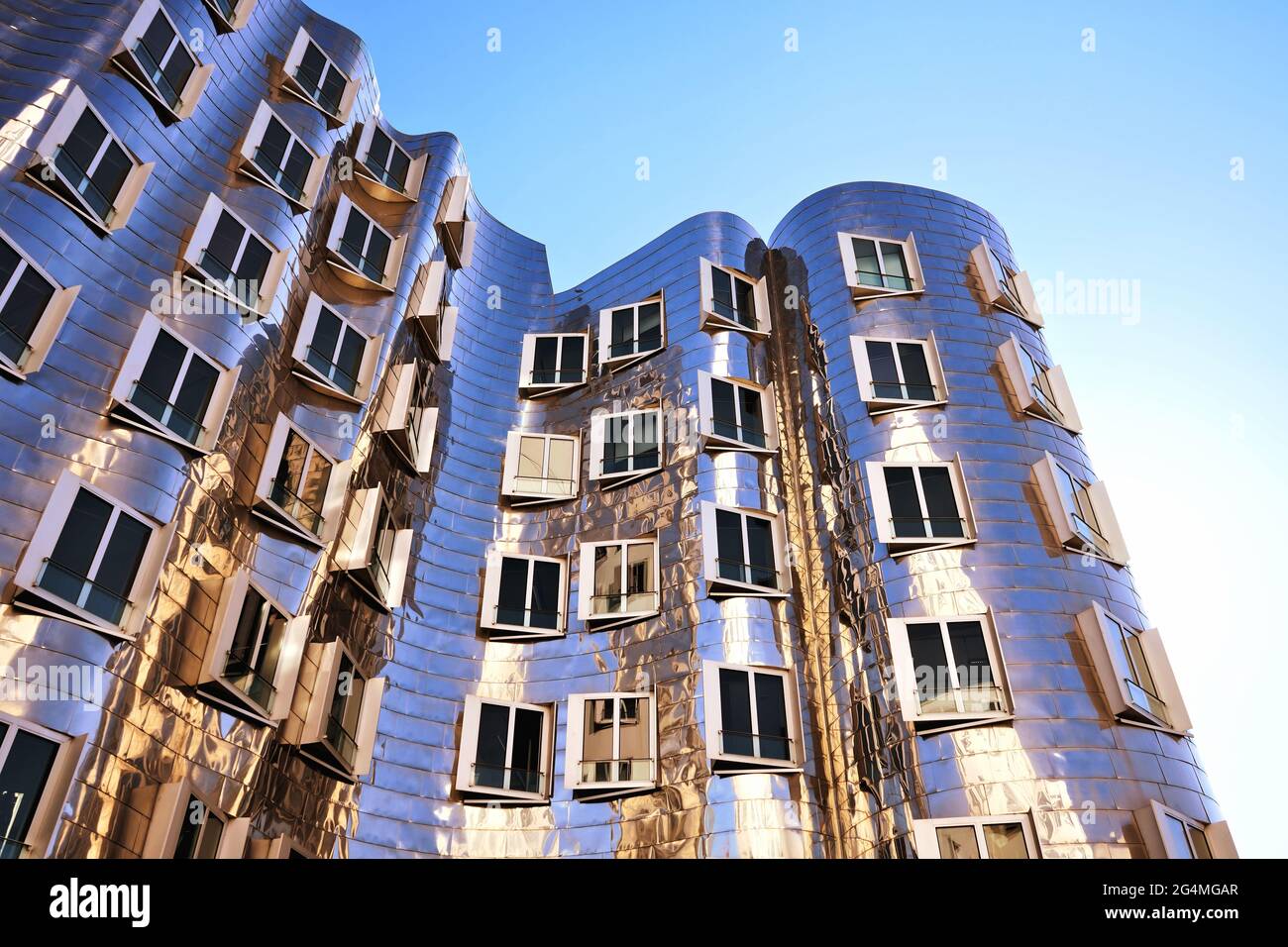Futuristic shiny building designed by the American star architect Frank O. Gehry at 'Neuer Zollhof' in the Medienhafen district in Düsseldorf. Stock Photo