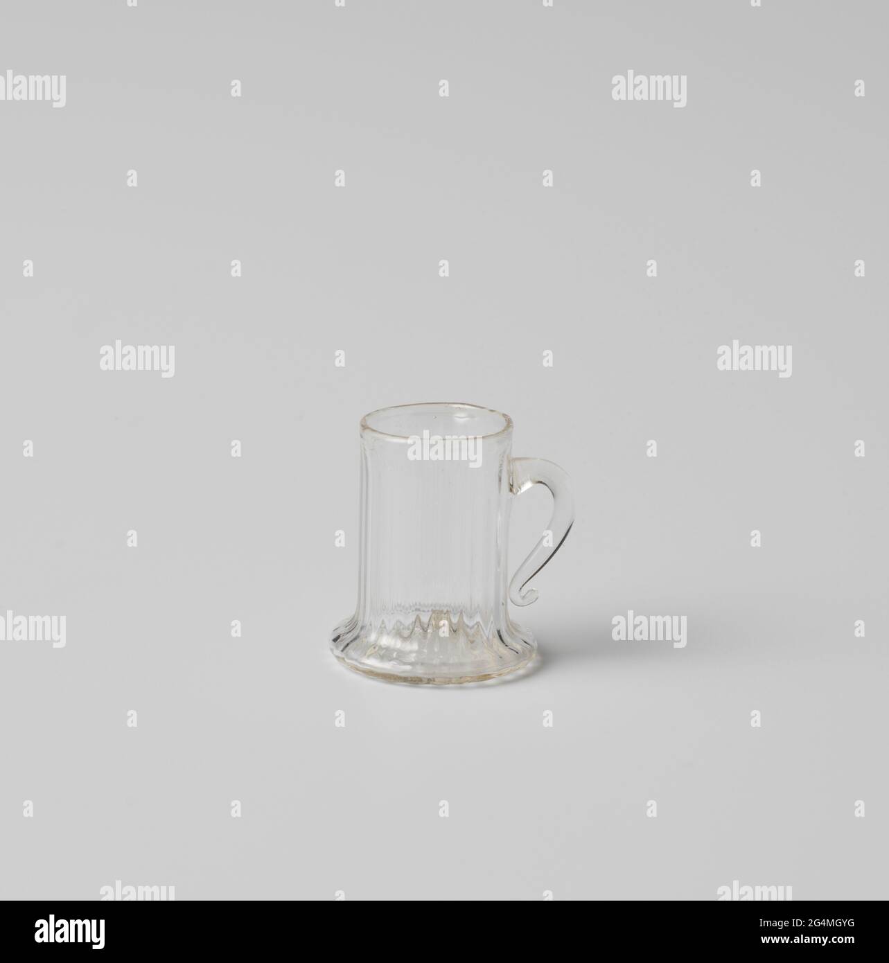 Cup with ear, body cylindrical with vertical ridges. Cup of bright ...