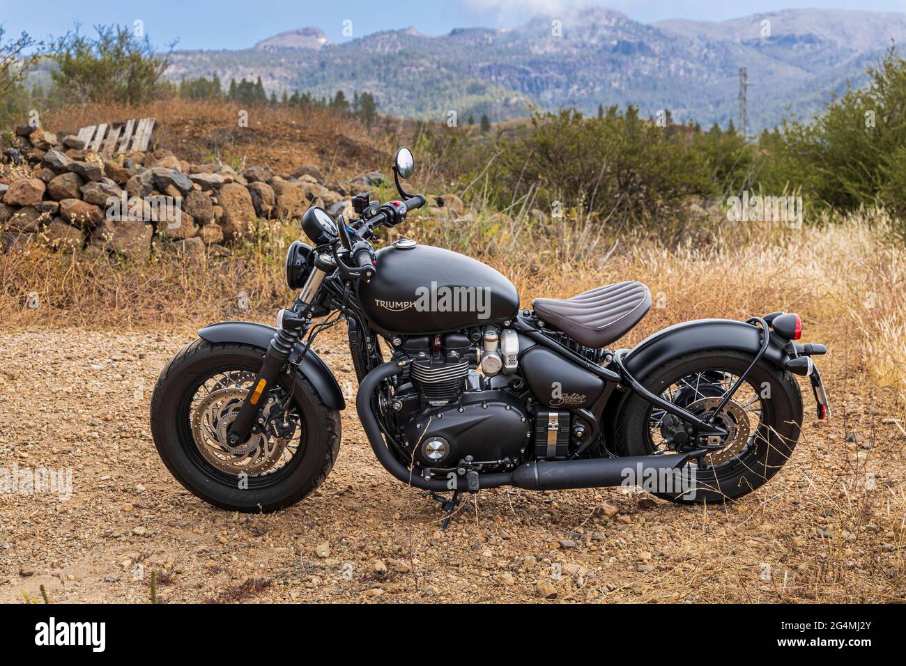 Retro style bike. Triumph Bobber, parked on rough ground in Tenerife, Canary Islands, Spain Stock Photo