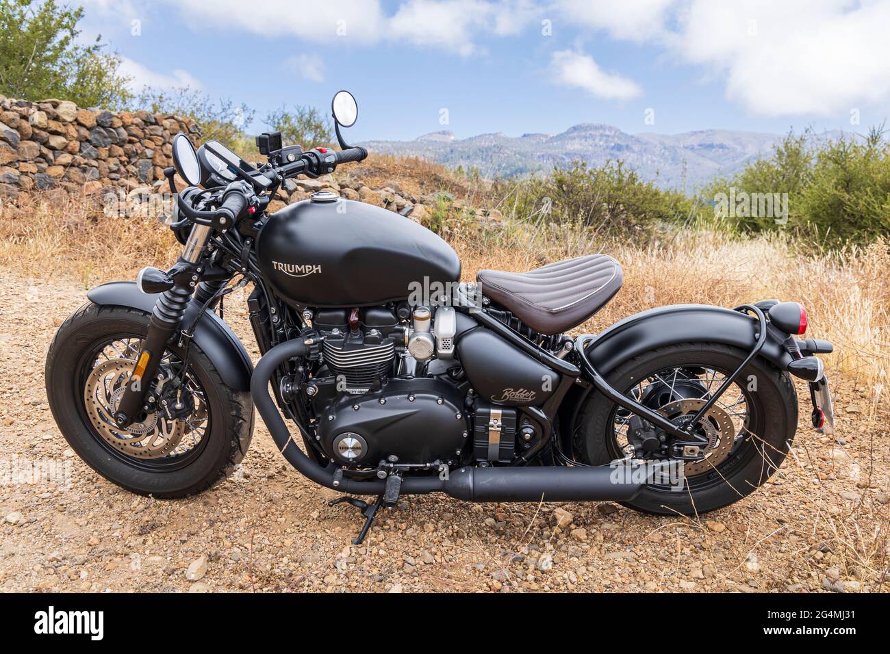 Retro style bike. Triumph Bobber, parked on rough ground in Tenerife, Canary Islands, Spain Stock Photo