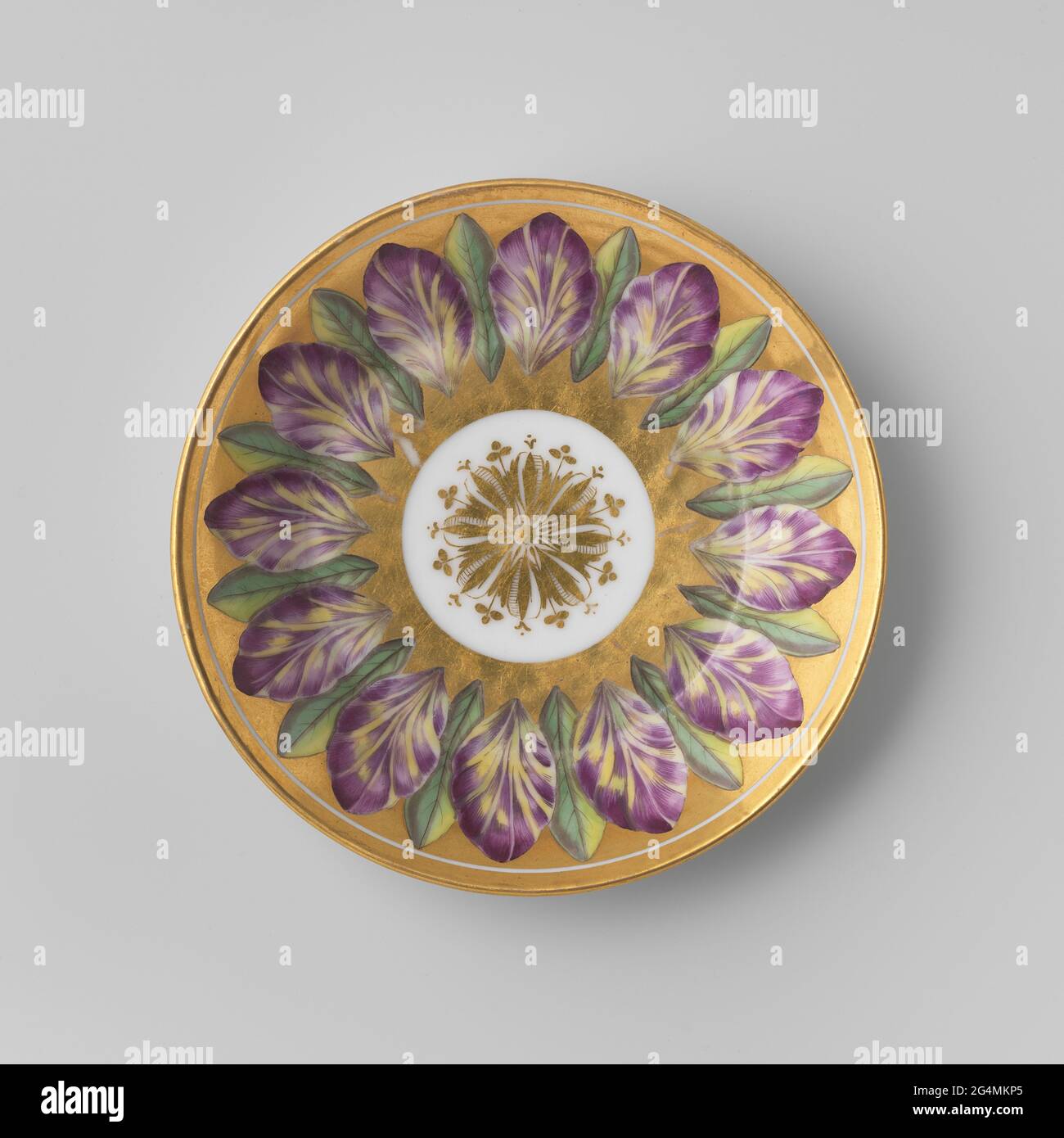 Dish with leafwork on golden fond. Dish of porcelain, decorated with purple and green leaves on golden fond. Stock Photo