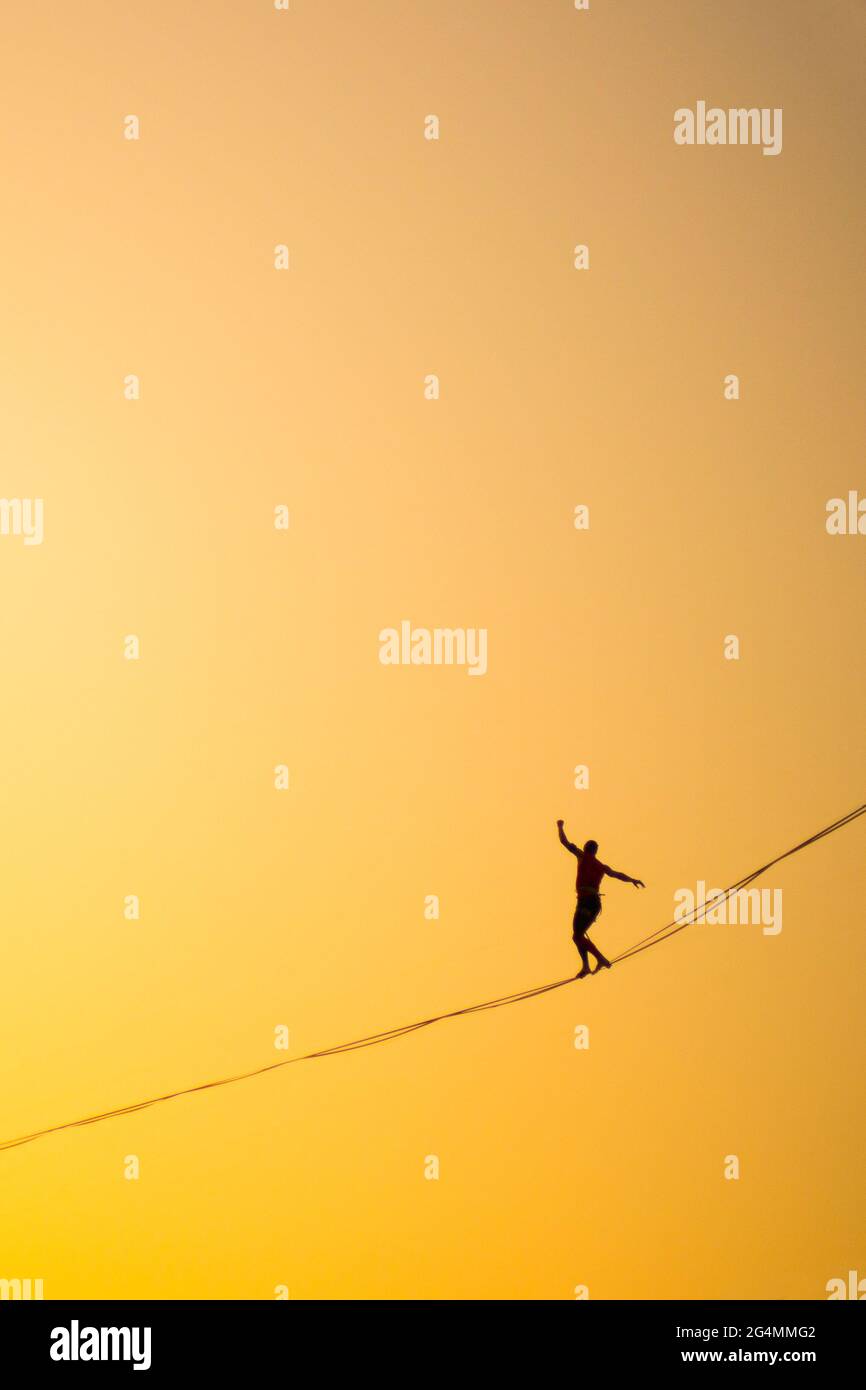 Man balancing on rope hi-res stock photography and images - Alamy