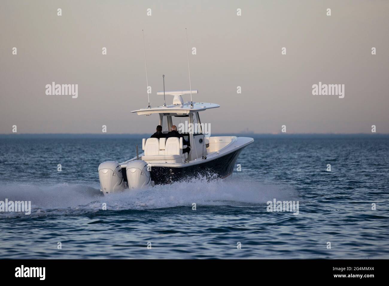 A center console boat cruising alone on an empty lake. Stock Photo