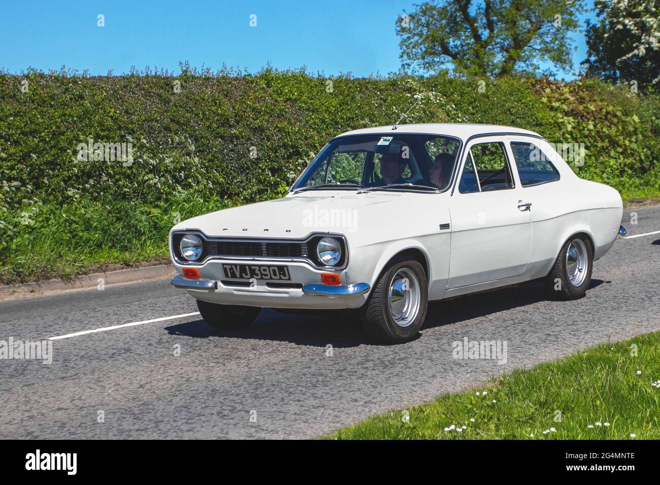 1970 70s white Ford Escort 1558cc 2dr saloon, en-route to Capesthorne Hall classic May car show, Cheshire, UK Stock Photo